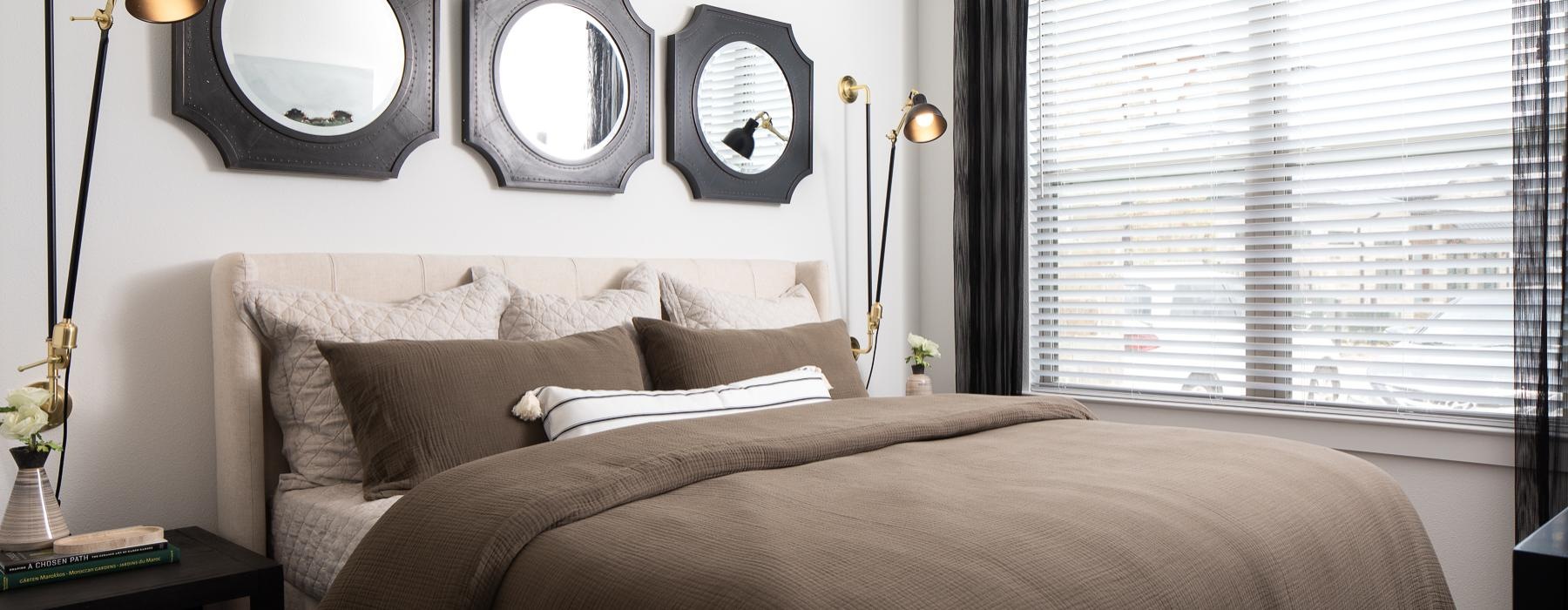 a bed with a mirror above it