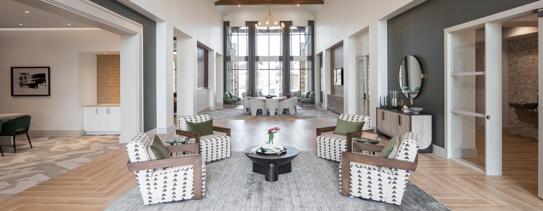 a large living room with a chandelier and a table